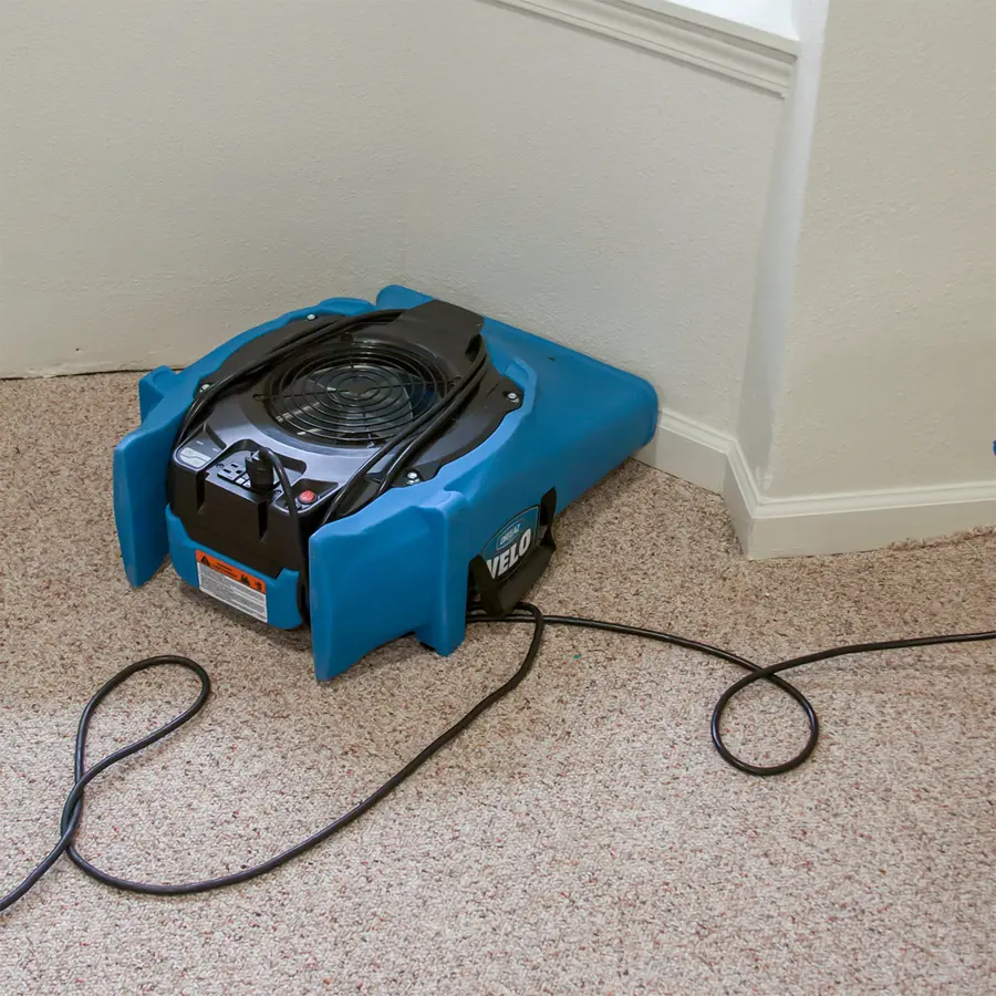 An air mover drying a tile floor
